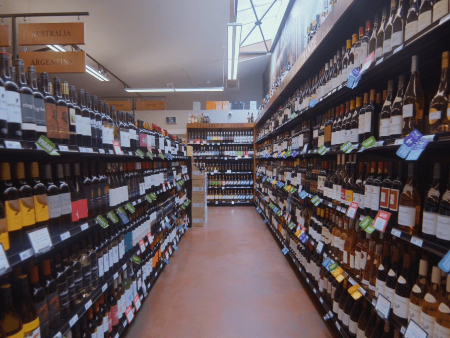 Long wine aisle with bottles stretching to the back of the store
