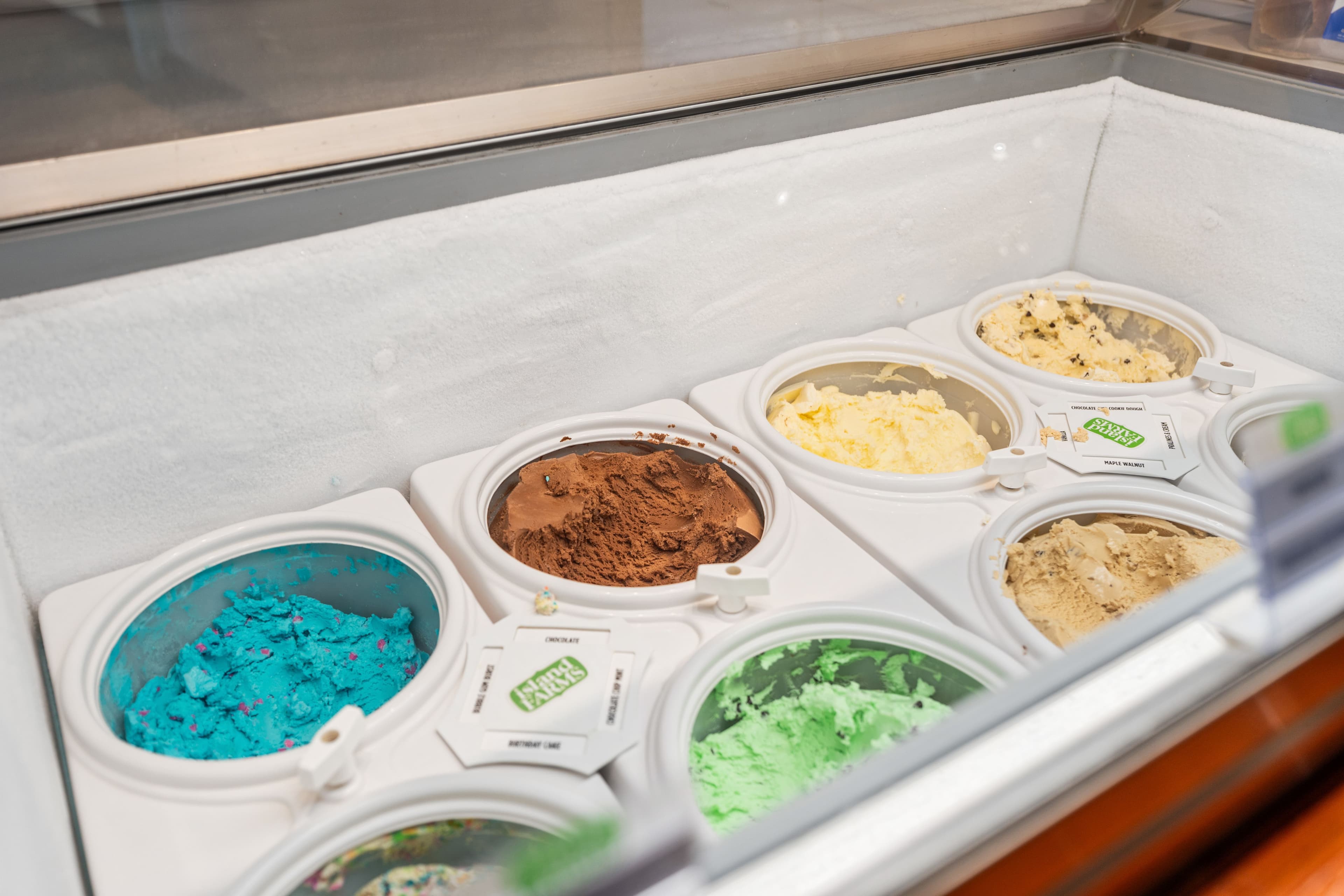 Colourful tubs of ice cream in the freezer