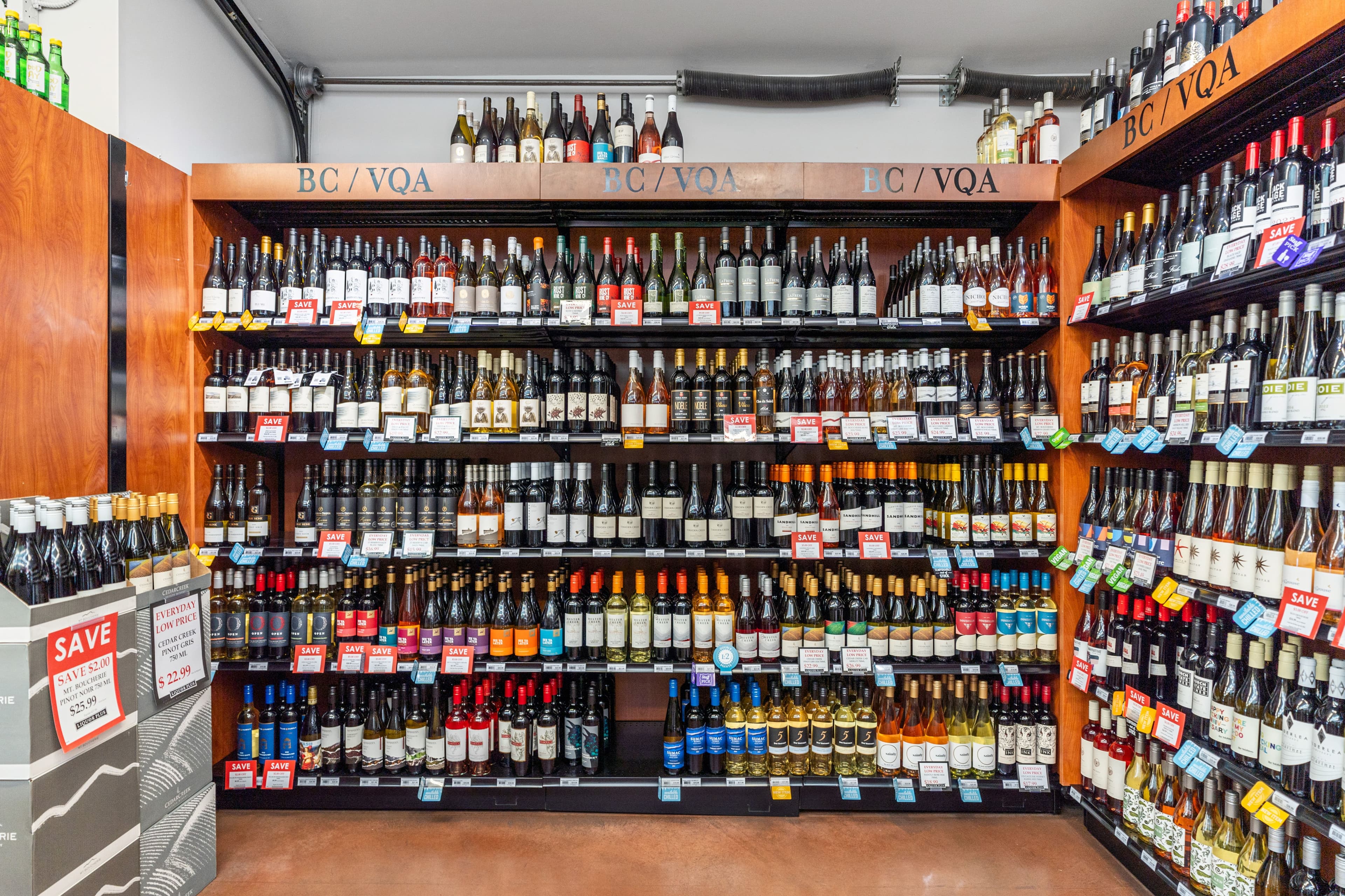 BC/VQA wine wall with rows of bottles and shelf-talker tags