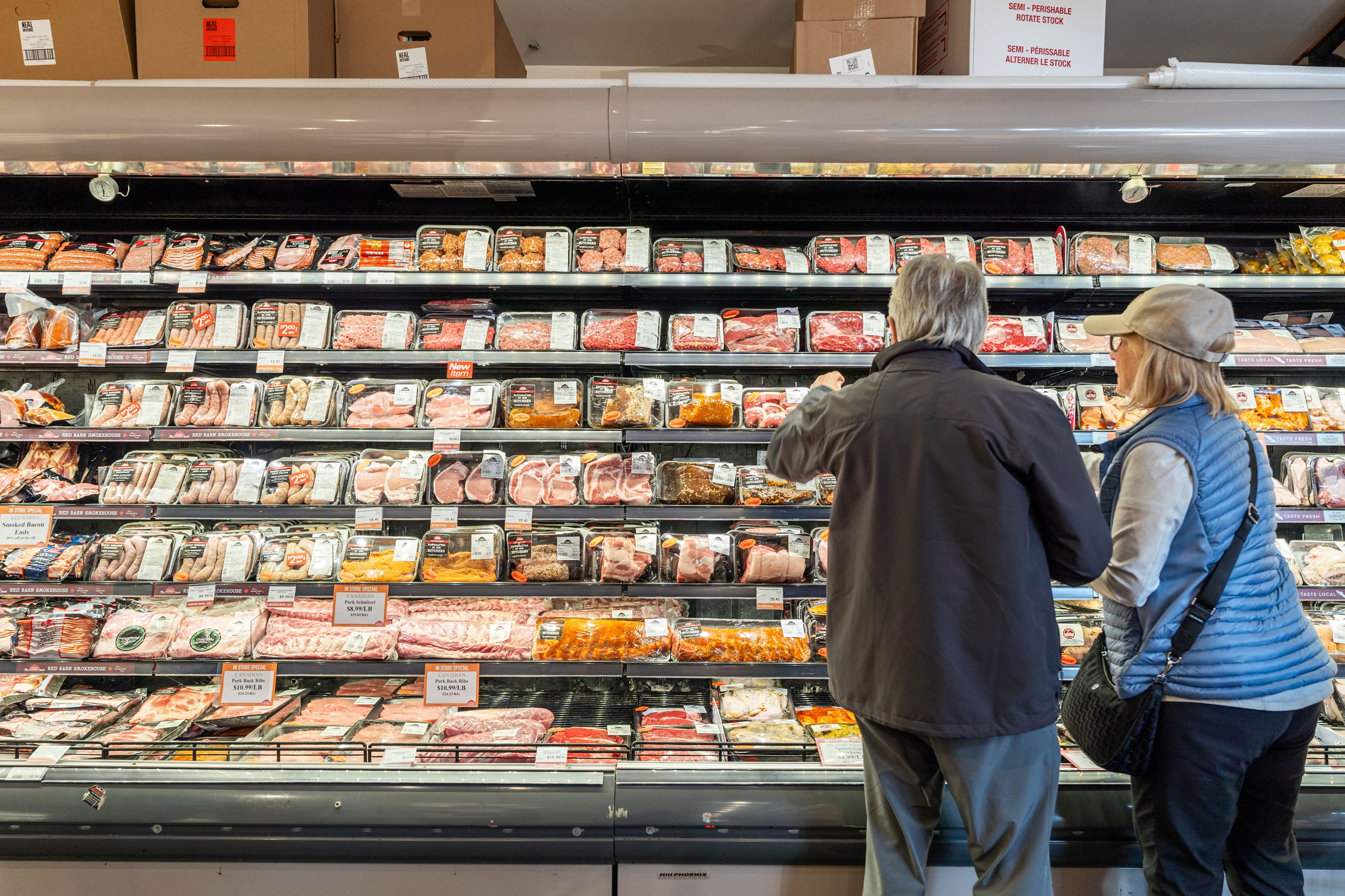 Couple browsing the meat case together