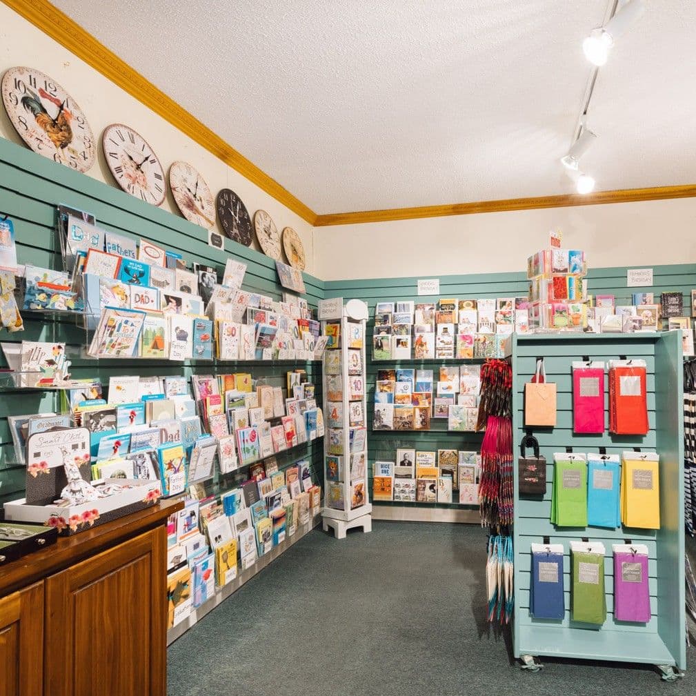 Wide view of Paper Chain with clocks lining the walls and cards across every shelf