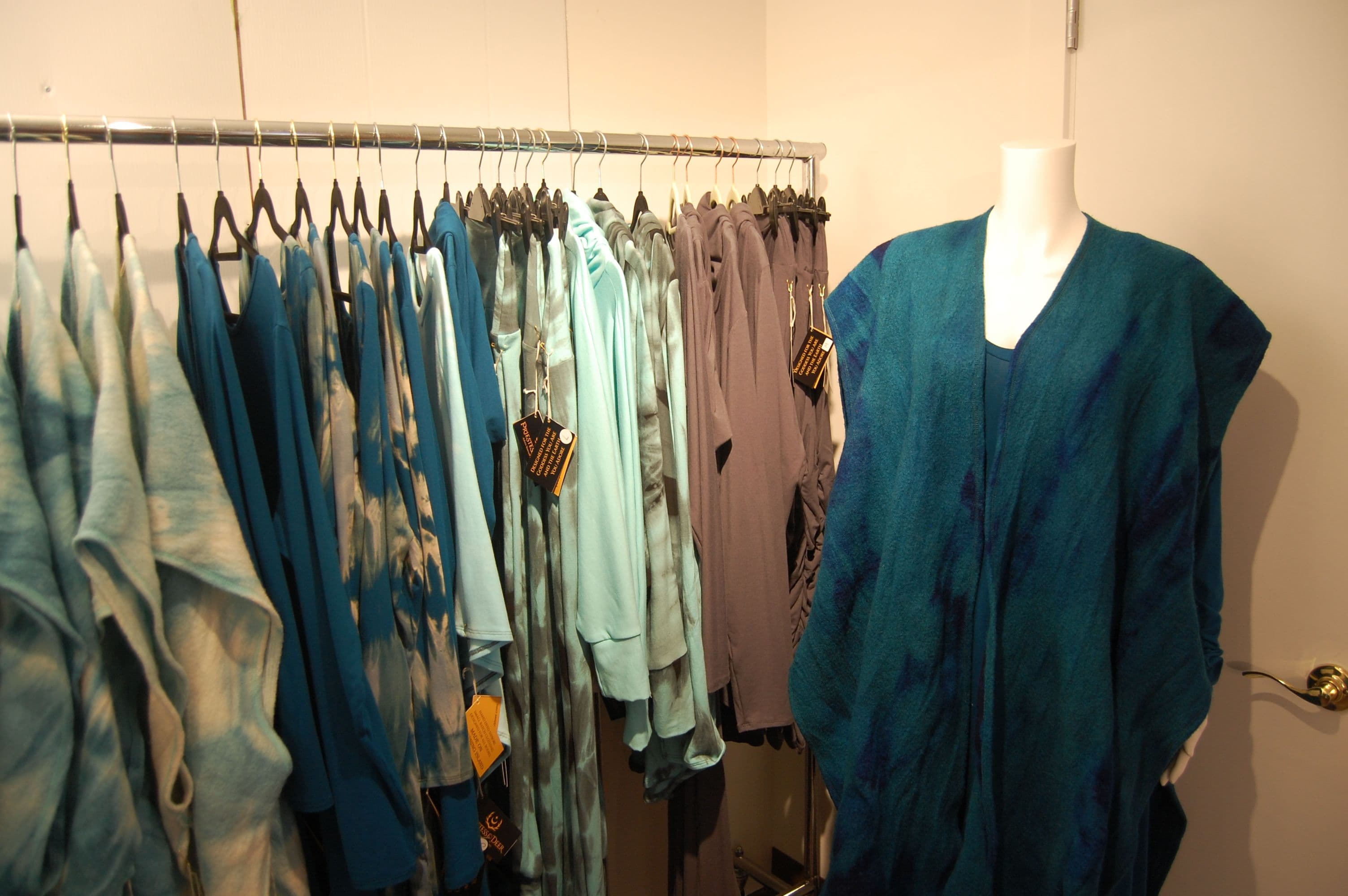 Teal tie-dye garments with a draped mannequin