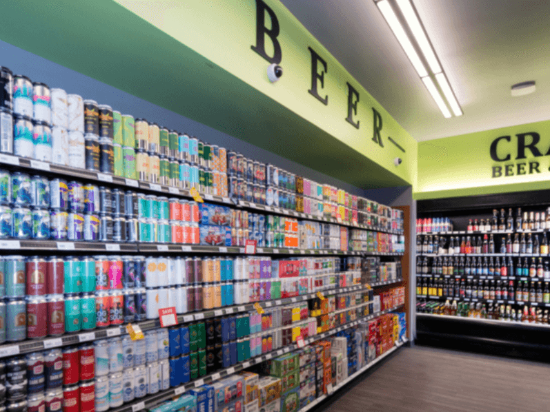 Beer aisle with green walls and a colourful range of cans