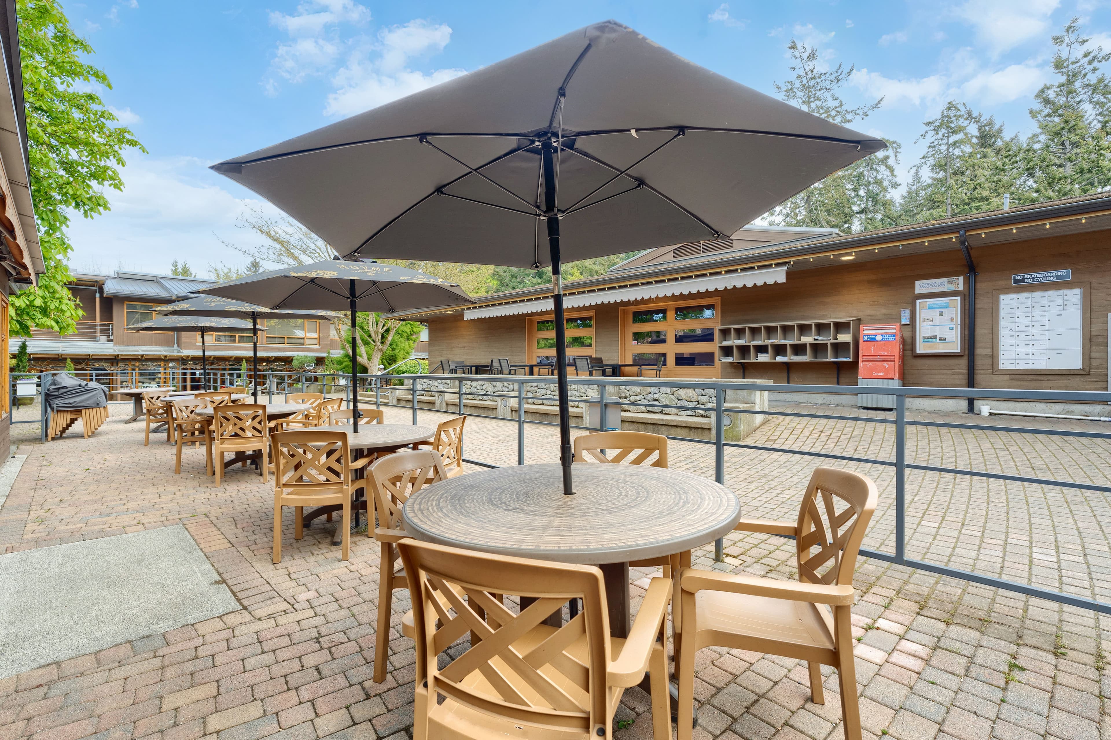 Outdoor patio with grey umbrellas and cobblestone paving