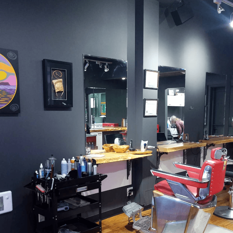 Row of stylist mirrors along the dark accent wall