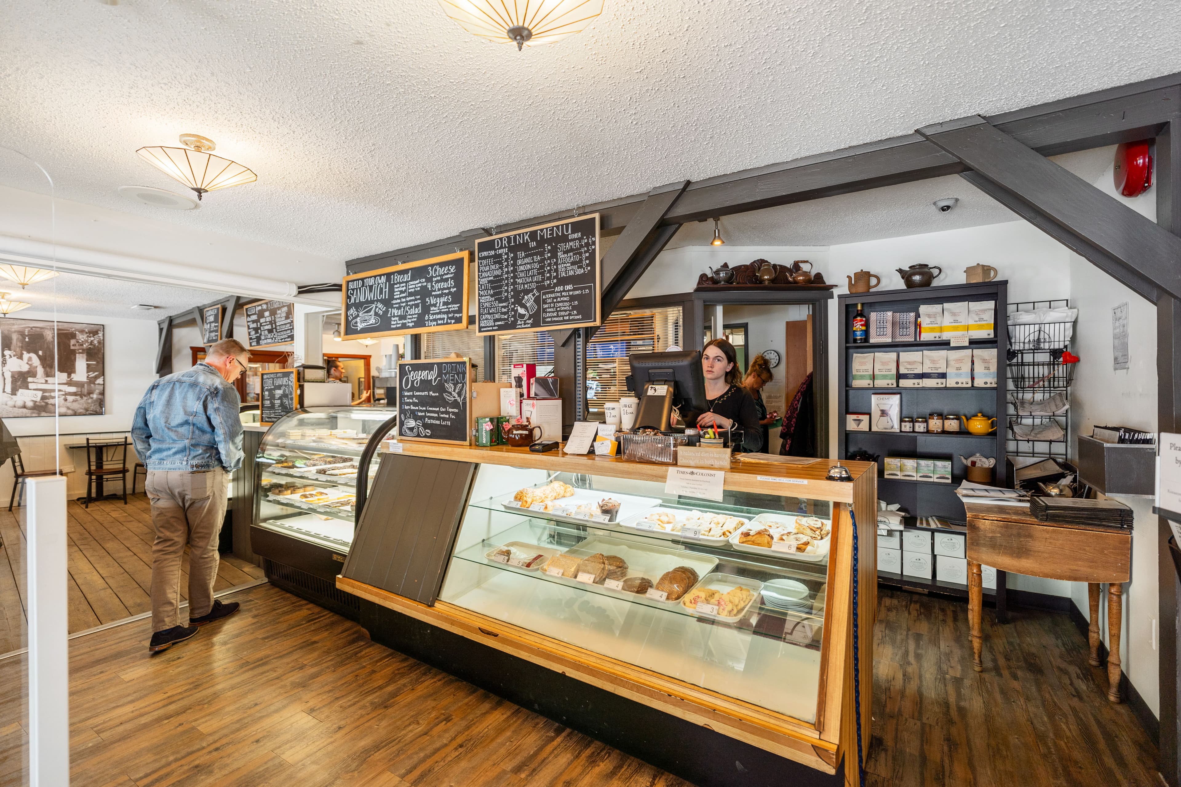 Bakery counter with customers and staff at the till