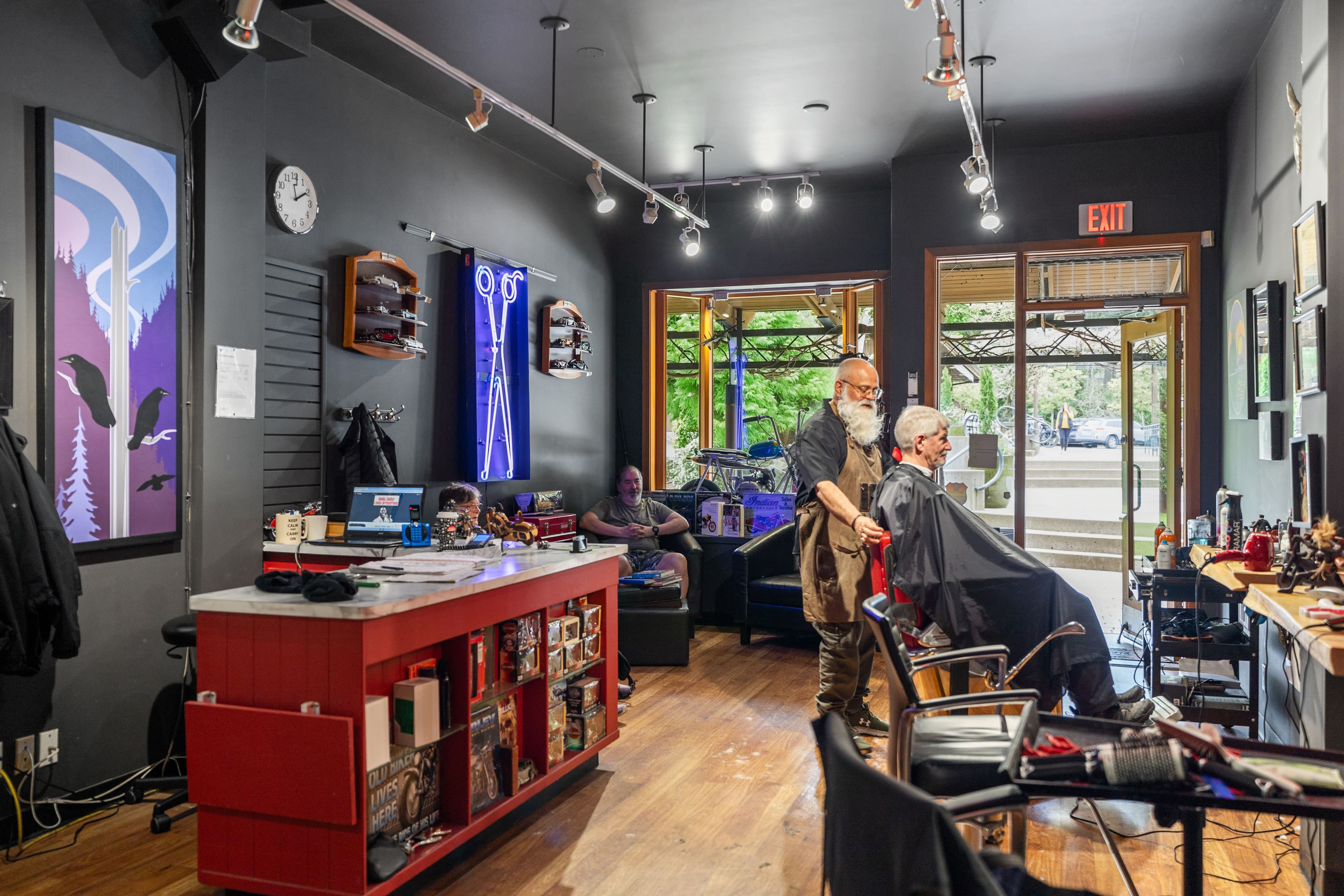Customer being styled with the open shop door framing the street view beyond
