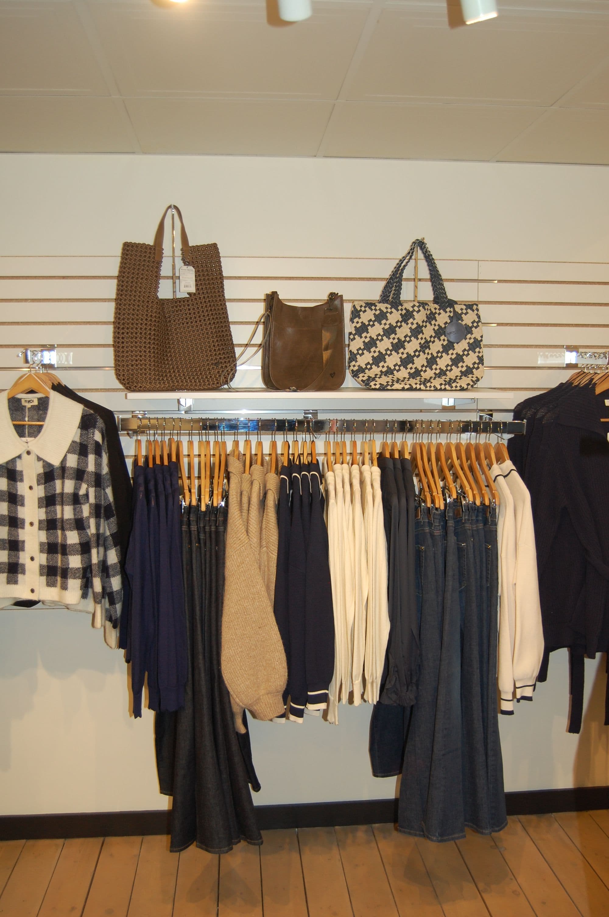 Denim-and-neutrals rack with a houndstooth tote on display