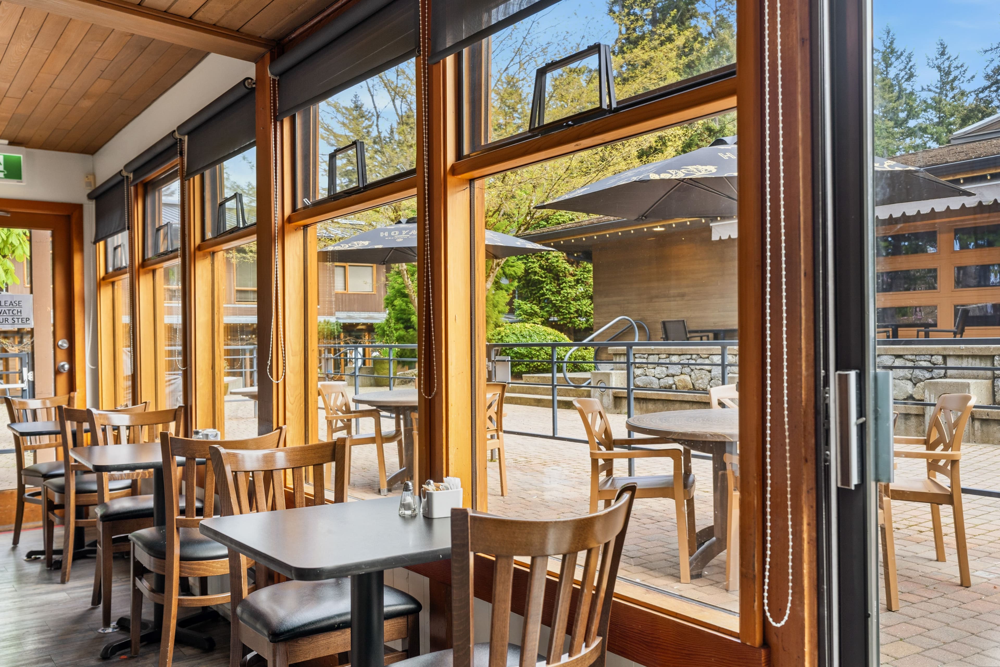 Peaceful interior dining room with tables and big windows